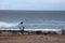 Man looking at the sea where surfers ride the waves