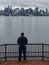 Man looking at Seattle skyline from Gas Works Park in Seattle, Ohio