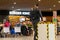 Man looking towards the Burger King food area in Lyon-Saint Exupery Airport, while waiting for his flight