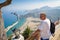 Man is looking at Tsampika bay from balcony on Rhodes island, Greece