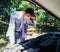 Man looking under the hood of car