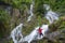 man looking waterfall in Deep forest at (Krok E Dok Waterfall Sa