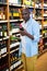 Man looking at wine bottle in grocery section