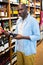 Man looking at wine bottle in grocery section at supermarket