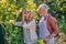 Man looking at woman enjoying scent of flower