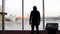 A man looks at a beautiful view of the city and a frozen lake from the observation deck. Media. Rear view of a young man