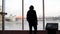 A man looks at a beautiful view of the city and a frozen lake from the observation deck. Media. Rear view of a young man