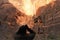 Man looks through binoculars at waterfall in Zion National Park