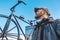 A man looks at a large sculpture of a bicycle