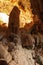 A man looks at the large stalagmite in the limestone cave