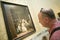 Man looks at Las Meninas by Velazquez as shown in the Museum de Prado, Prado Museum, Madrid, Spain