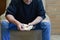 A man looks at the money he took out of his wallet, examines, counts, sitting on a chair