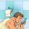 a man looks at the phone in the toilet. Morning reading of work mail. Businessman daily routine