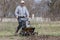 Man loosens the soil cultivator