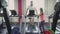 Man loses weight on a treadmill in gym with personal trainer. Health and fitness. Warm up before the Exercises and