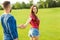 Man in love holding the hand of a girl and they walk in the park