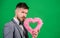 Man in love strict wear formal suit celebrate valetines day green background. Spread love around. Happy valentines day