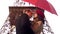 Man in love about to kiss beautiful woman under umbrella, romantic date in Paris