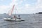 Man lowering catamaran into river, Novosibirsk, Russia