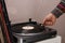 man lowers the tonearm on a vinyl record