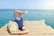 Man lying on the dock with a book