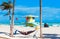 A man is lying in a hammock against the background of the sea in Miami, Florida, USA