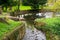 A Man-Made Cobblestone Stream Leading to a Lake in a Park