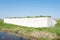 Man made wall with holes intended for nests of barn swallows in the dutch polder landscape