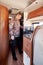 Man make coffee using cezve standing inside of motor home