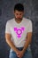 A man with make up in t-shirt with third gender symbol- transgender.