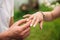 Man makes a marrige proposal to a girl. Gives her a ring for the engagement. Close-up hands