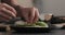 Man makes sandwich with avocado and cream cheese