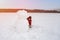 A man makes a snowman in a snow-covered field in the open air. Winter time. Artistically colored photography