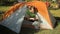 Man makes touch tablet out of the tent. Open the tent, touch tablet\'s screen and close the tent. Sunny day in the forest