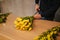 Man making flower bouquet. Spring yellow boquet with tulips