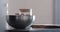 man making granola pour honey into steel bowl on kitchen countertop