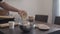 Man making granola pour oat flakes into steel bowl on kitchen countertop