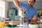 Man Making Healthy Juice Drink With Fresh Ingredients In Electric Juicer After Exercise