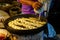 Man making jalebi,A sweet snack made by deep-frying all-purpose flour batter in pretzel or circular shapes, which are then soaked