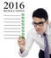 Man making a list of business resolutions for 2016