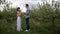 Man making marriage proposal to woman in orchard