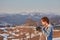 man making photo at snowy highland