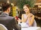 Man making proposal to happy woman at restaurant
