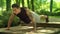 Man making push up exercise in park. Fitness man doing pushups outdoor