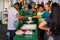 Man making tapioca pancakes and clients looking and waiting at Expoeiras