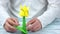 Man making yellow origami flower.