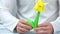 Man making yellow origami tulip.