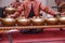 Man with Malay songket costume playing traditional music instrument called Gamelan. selective focus shot