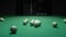 A man a man breaks a pyramid of white billiard balls. Start playing Russian billiards