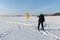 Man man lifting a kite from the snowy surface of a reservoir, Novosibirsk, Russia